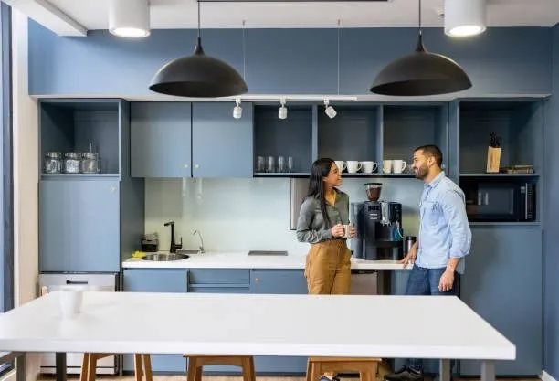 Employees in an office kitchen.